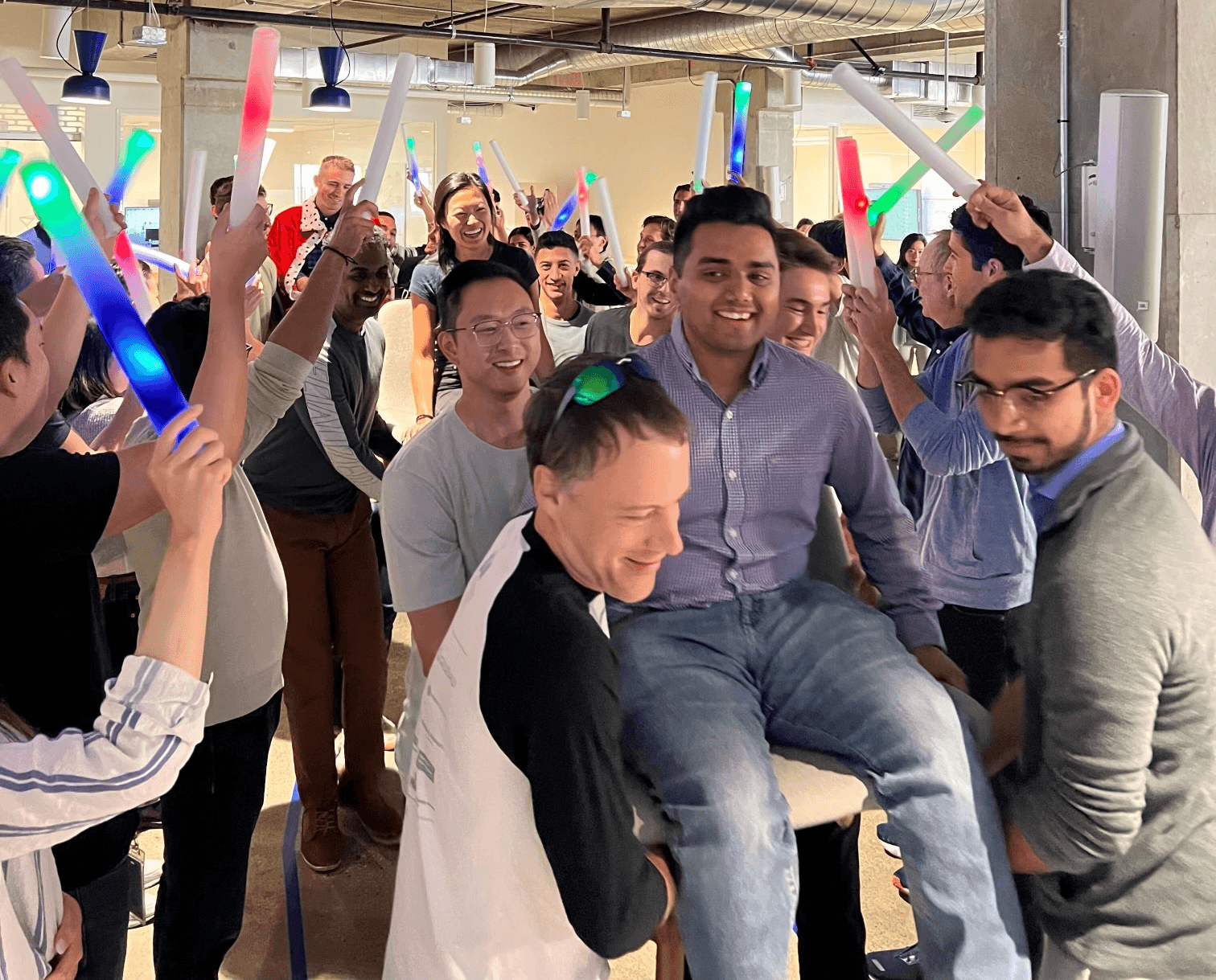 A group of people carrying an award winner in a throne