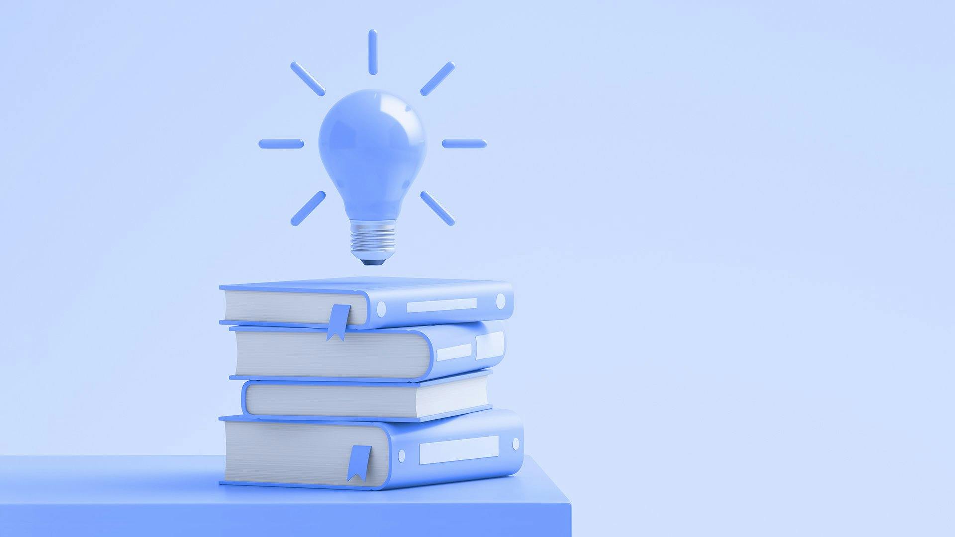 Stack of books with lightbulb on top