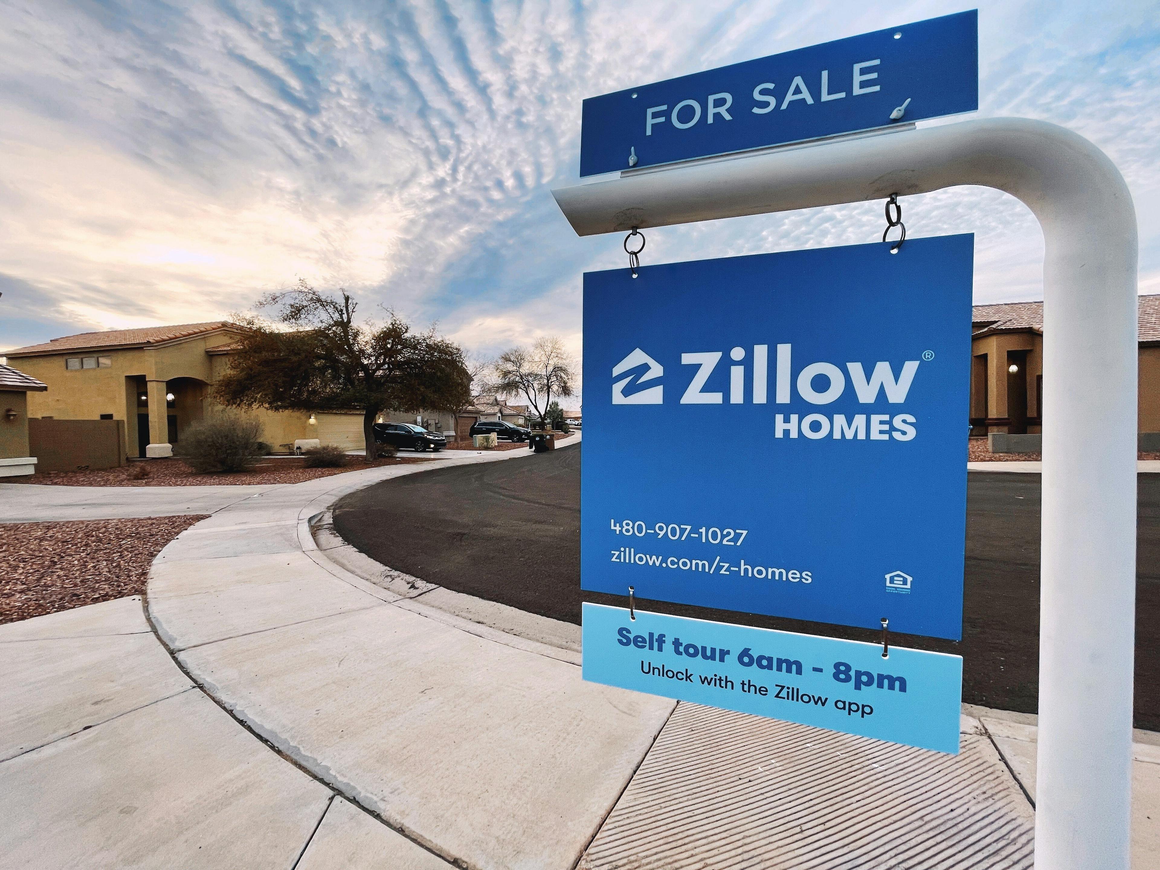 Poster showcasing Zillow homes for sale with corresponding phone numbers for potential buyers