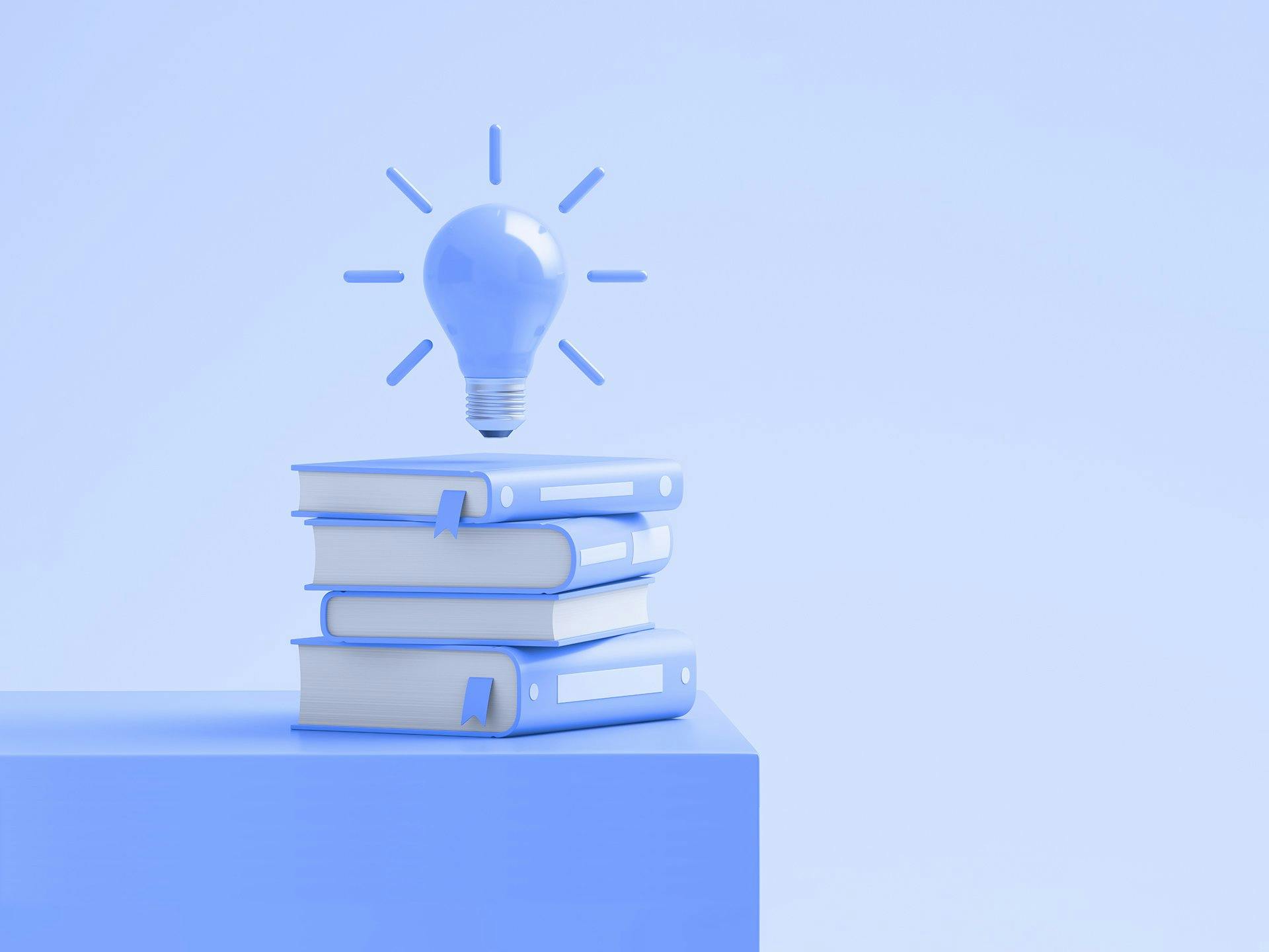 Stack of books with lightbulb on top